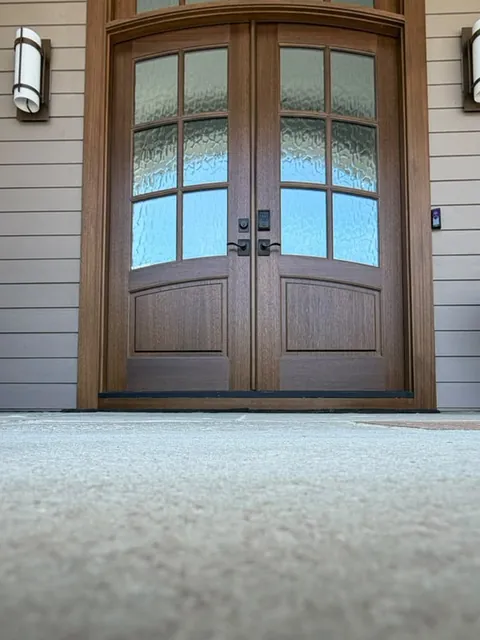 Arched solid wood entry doors and custom molding by Ocean Bay Interiors