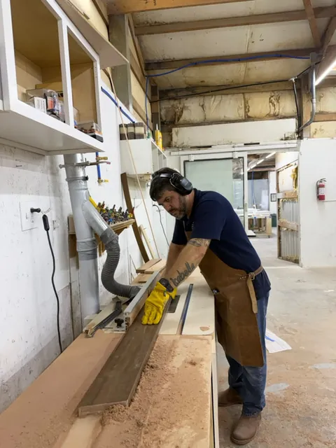 Ocean Bay craftsman cutting hardwood at the workshop