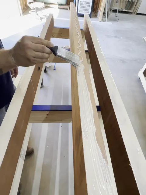 Carved clubhouse sign, spreading glue for the panel glue-up (Commercial)