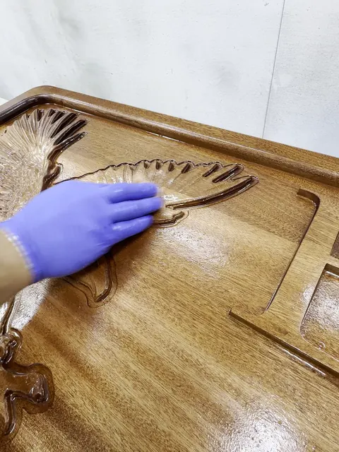 Carved clubhouse sign, wiping the finish into the carved eagle (Commercial)
