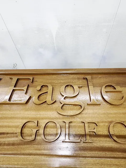 Carved clubhouse sign, glossy finished lettering close-up (Commercial)