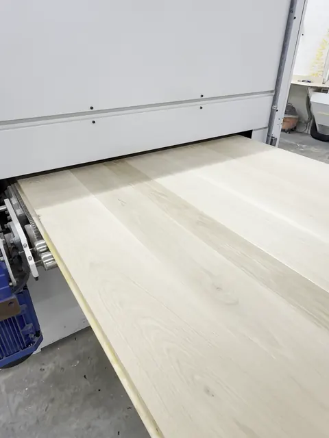 Oak slat wall & floating vanity, oak panel coming out of the wide-belt sander (Jimmy)