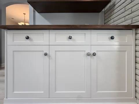 Walnut floating shelves and white shaker base cabinets