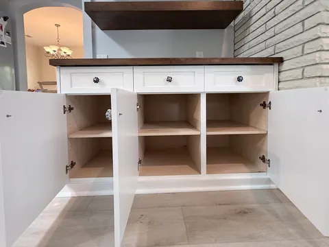 Walnut floating shelves and white shaker base cabinets