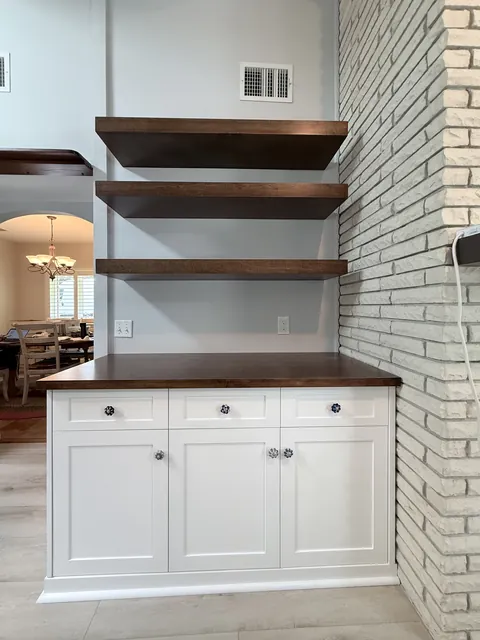 Walnut floating shelves and white shaker base cabinets