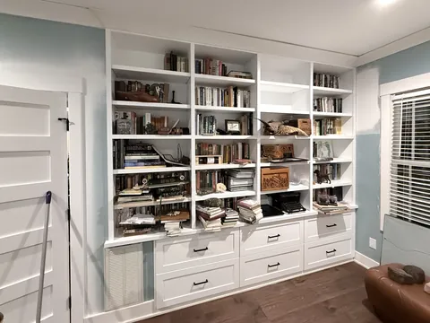 Custom white bathroom cabinetry and built-in display cabinets