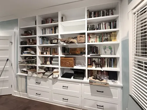 Custom white bathroom cabinetry and built-in display cabinets