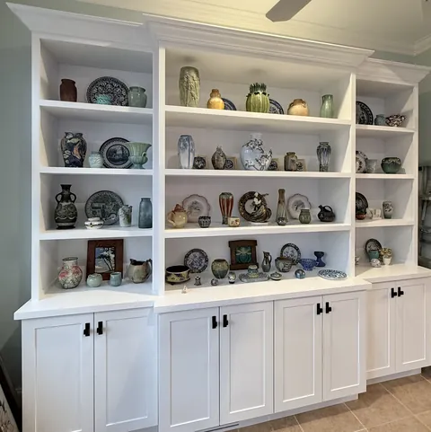 Floor-to-ceiling white built-in display cabinet, from 3D design to installed