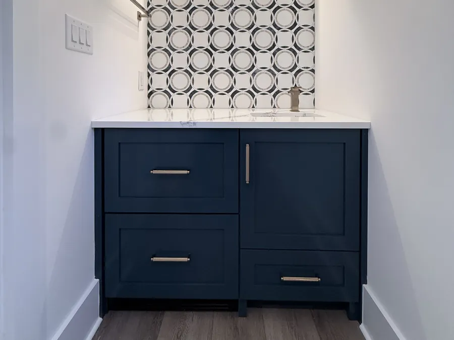 Navy custom bathroom vanity with shaker drawers, white quartz top and patterned tile backsplash, Little River, SC