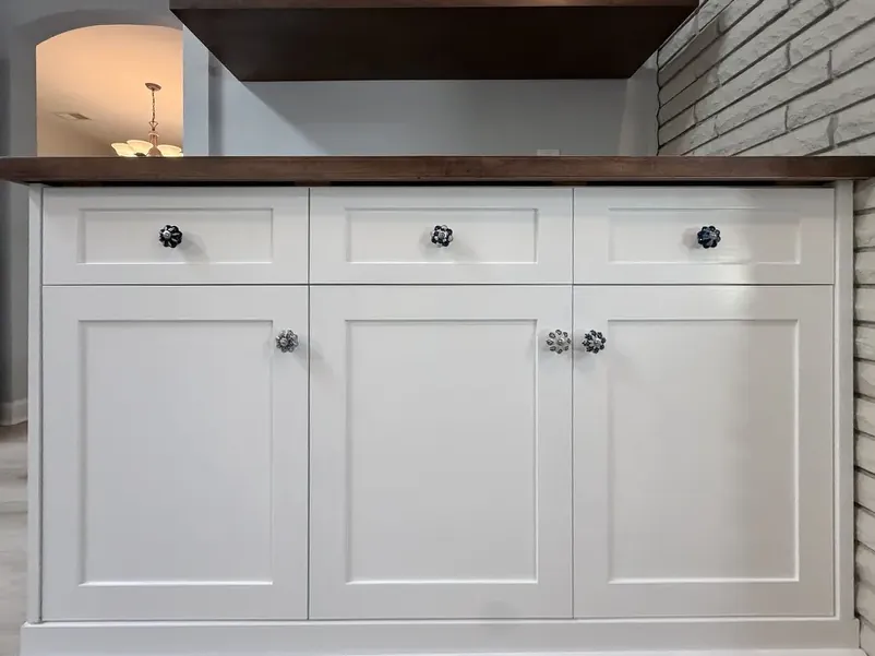 Custom white kitchen cabinets with a solid walnut countertop built by Ocean Bay Interiors in Little River, SC