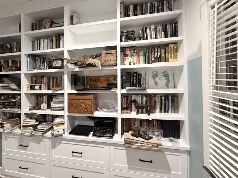 Custom home office wall with open shelving, closed storage and drawers built to the room's exact dimensions